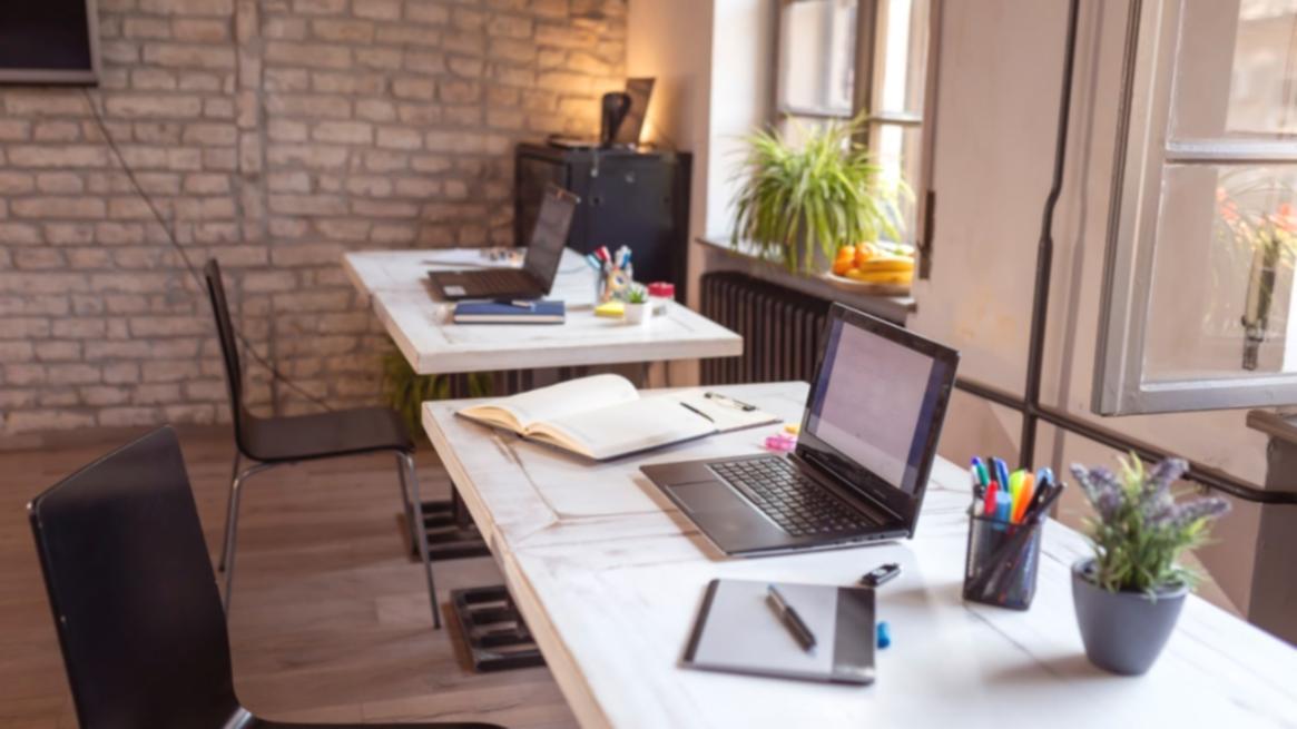 Professional workspace environment showing collaborative business forecasting discussion